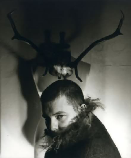 Alexander McQueen posed in front of Antlers by Unknown